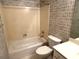 Bathroom featuring a bathtub and shower combination with patterned wallpaper at 4091 Oberon Se Ct, Smyrna, GA 30080