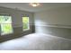 Carpeted bedroom with large windows and trim at 4091 Oberon Se Ct, Smyrna, GA 30080