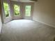 Bright bedroom with neutral carpet and three large windows overlooking the greenery at 4091 Oberon Se Ct, Smyrna, GA 30080