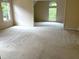 Expansive room with neutral walls, carpet and large windows at 4091 Oberon Se Ct, Smyrna, GA 30080