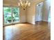 Dining room with chandelier lighting and large window with lush green scenery at 4091 Oberon Se Ct, Smyrna, GA 30080