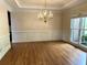 Dining room featuring hardwood floors, wainscoting and chandelier lighting at 4091 Oberon Se Ct, Smyrna, GA 30080