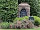 Stone community sign surrounded by lush landscaping and colorful flowers at 4091 Oberon Se Ct, Smyrna, GA 30080