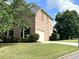 Side view of this brick home with manicured lawn and an attached two car garage at 4091 Oberon Se Ct, Smyrna, GA 30080