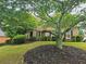 Beautiful two-story brick home with a landscaped front yard and mature trees providing shade at 4091 Oberon Se Ct, Smyrna, GA 30080