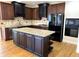 Modern kitchen with two-tone cabinetry, an island with a light countertop, and stainless steel appliances at 4091 Oberon Se Ct, Smyrna, GA 30080
