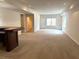 Expansive living room with a bar, neutral carpet, and natural light at 4091 Oberon Se Ct, Smyrna, GA 30080