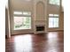 Living room with hardwood floors, fireplace, and large windows allowing natural light to come through at 4091 Oberon Se Ct, Smyrna, GA 30080