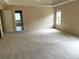 Spacious main bedroom with carpet, a view of the en suite, and a window at 4091 Oberon Se Ct, Smyrna, GA 30080