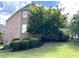 Back of house and brick side with lush greenery, a wooden fence, and a sunroom with many windows at 4091 Oberon Se Ct, Smyrna, GA 30080