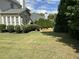 Brick side of the house with mature landscaping providing shade and curb appeal at 4091 Oberon Se Ct, Smyrna, GA 30080