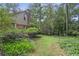 Lush backyard features mature landscaping, a brick chimney, and plenty of shade at 491 Hemlock Sw Dr, Marietta, GA 30064
