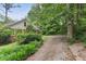 Beautiful home exterior features brick and siding, mature landscaping, and a paved driveway at 491 Hemlock Sw Dr, Marietta, GA 30064