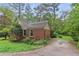 Charming exterior features brick and siding, mature landscaping, and a paved driveway at 491 Hemlock Sw Dr, Marietta, GA 30064