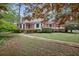 Charming one-story brick home with lush landscaping and a brick pathway leading to the front at 491 Hemlock Sw Dr, Marietta, GA 30064