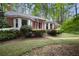 This one-story brick home is surrounded by mature trees and flowering bushes at 491 Hemlock Sw Dr, Marietta, GA 30064