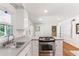 Bright eat-in kitchen features white cabinetry, stainless steel appliances, and durable countertops at 491 Hemlock Sw Dr, Marietta, GA 30064