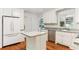 This kitchen features white cabinetry, stainless appliances, and a kitchen island at 491 Hemlock Sw Dr, Marietta, GA 30064