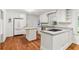 Bright kitchen features white cabinets, stainless appliances, and hardwood floors at 491 Hemlock Sw Dr, Marietta, GA 30064
