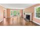 Spacious living room with large windows, a fireplace, and hardwood floors at 491 Hemlock Sw Dr, Marietta, GA 30064