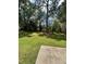 Large backyard with healthy lawn, large trees, and the back of a house at 1736 Almand Creek Sw Dr, Conyers, GA 30094