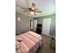 This bedroom has a ceiling fan, carpet, a tv, and neutral colored walls at 1736 Almand Creek Sw Dr, Conyers, GA 30094