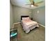 This cozy bedroom features a ceiling fan and a bed with decorative pillows at 1736 Almand Creek Sw Dr, Conyers, GA 30094