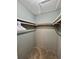 Walk-in closet featuring neutral colored walls, carpeted floor, and shelving at 1736 Almand Creek Sw Dr, Conyers, GA 30094
