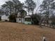Charming home featuring a screened porch, surrounded by mature trees and an expansive front yard at 2010 Mcafee Pl, Decatur, GA 30032