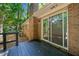 Backyard view from stained wood deck with a sliding glass door, and brick exterior walls at 2683 Stardust Trl, Decatur, GA 30034