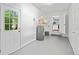 Basement featuring painted floor, water heater, open doorway to kitchen, and glass door to the exterior at 2683 Stardust Trl, Decatur, GA 30034