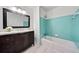 Bathroom with dark wood vanity, bathtub with shower, and blue tiling at 2683 Stardust Trl, Decatur, GA 30034