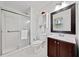 Bathroom featuring a tiled shower with glass door, vanity with dark wood cabinets and mirror, and tiled floor at 2683 Stardust Trl, Decatur, GA 30034
