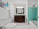 Bathroom featuring dark wood vanity and a bathtub with blue tile at 2683 Stardust Trl, Decatur, GA 30034