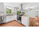 Modern kitchen with white cabinets, stainless steel appliances, and stylish range hood at 2683 Stardust Trl, Decatur, GA 30034