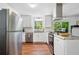 Modern kitchen boasts stainless steel refrigerator, white cabinets and granite countertops at 2683 Stardust Trl, Decatur, GA 30034