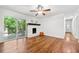 Living room featuring hardwood floors, a fireplace, and sliding glass door to the deck at 2683 Stardust Trl, Decatur, GA 30034