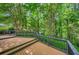 Large back deck with wood railings overlooks a beautiful wooded landscape at 3270 Leslie Ne Ct, Atlanta, GA 30345
