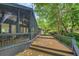 Spacious back deck leading to a screened porch, surrounded by lush trees at 3270 Leslie Ne Ct, Atlanta, GA 30345
