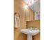 Well-lit bathroom with a pedestal sink and a mirrored medicine cabinet at 3270 Leslie Ne Ct, Atlanta, GA 30345