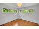 Well-lit bedroom featuring hardwood floors, white walls, and ample natural light from two windows at 3270 Leslie Ne Ct, Atlanta, GA 30345