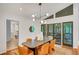 Open dining area with modern lighting, table with seating for six, and large windows with sliding glass doors at 3270 Leslie Ne Ct, Atlanta, GA 30345
