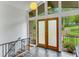 Bright entryway featuring a high ceiling, tiled floor, and elegant front doors with decorative metal work at 3270 Leslie Ne Ct, Atlanta, GA 30345