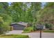 Driveway view of a brick home with a two-car garage and lots of greenery at 3270 Leslie Ne Ct, Atlanta, GA 30345