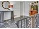 Foyer featuring stone floors, decorative table, and railing to another living space at 3270 Leslie Ne Ct, Atlanta, GA 30345