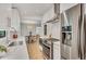 Modern kitchen with stainless steel appliances, white cabinetry, tile backsplash, and view to dining area at 3270 Leslie Ne Ct, Atlanta, GA 30345