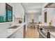 Open kitchen with white countertops and stainless steel appliances overlooks dining area at 3270 Leslie Ne Ct, Atlanta, GA 30345