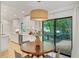 Bright kitchen with a view to the wood deck from a glass sliding door, and a round table for seating at 3270 Leslie Ne Ct, Atlanta, GA 30345