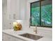 Close up of a bright kitchen featuring quartz countertops, modern faucet, and a window overlooking trees at 3270 Leslie Ne Ct, Atlanta, GA 30345