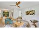 Inviting living room with modern furniture, ceiling fan, and view to a dining area and kitchen at 3270 Leslie Ne Ct, Atlanta, GA 30345